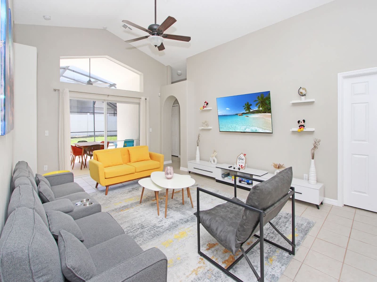 Castle Keys living room with bright seating and smart TV