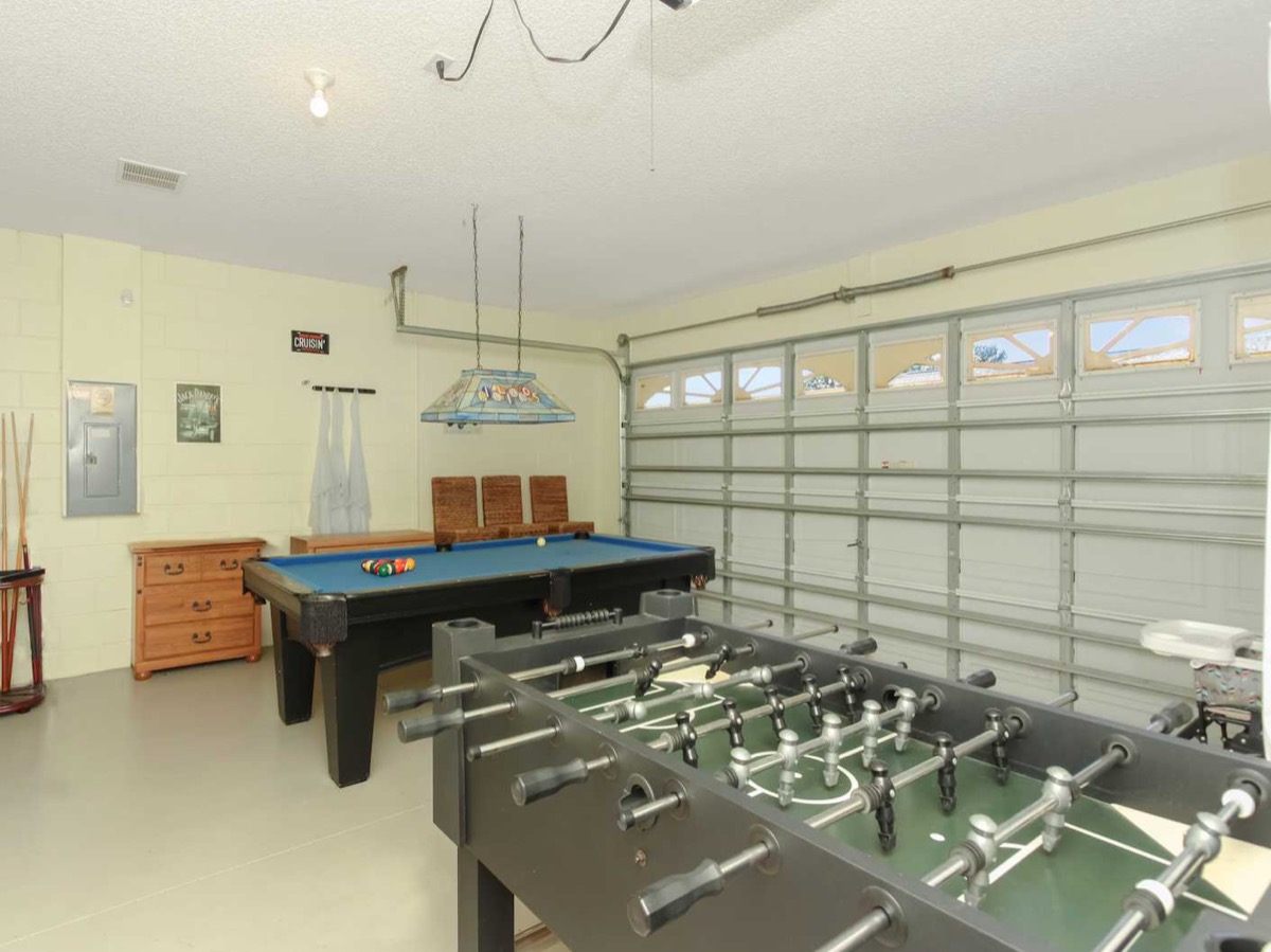 Castle Reeds game room with pool table and foosball